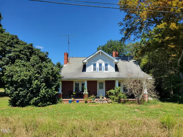 a front view of a house with swimming pool having outdoor seating