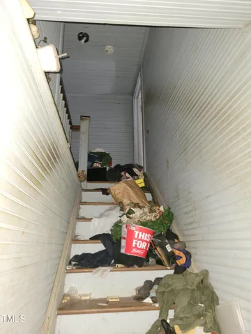 a street sign on a pole on a wall