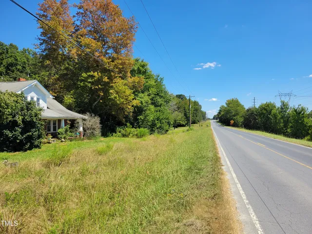 a view of a house with a yard and swimming pool