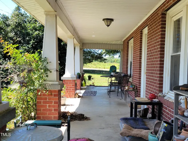 a building outdoor space with patio furniture and garden