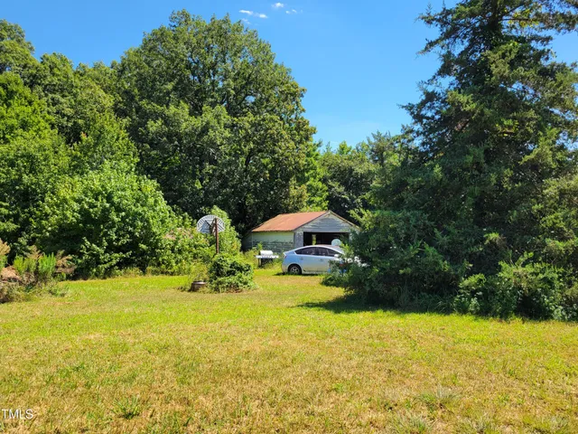 a view of a swimming pool with an outdoor seating and a yard