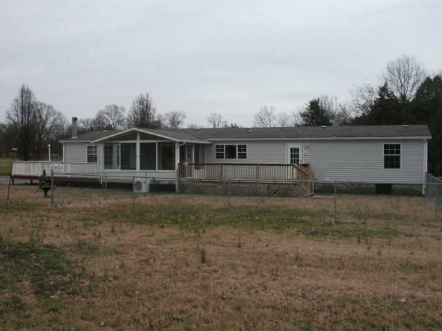 1791 Old Rome Pike Lebanon, TN 37087 - Photo 13 of 15 Rear view of home showing the sunroom, 2 large decks on either side, and fenced area.