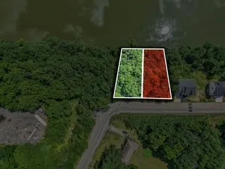 an aerial view of ocean with green space