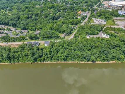 an aerial view of lake and residential houses with outdoor space