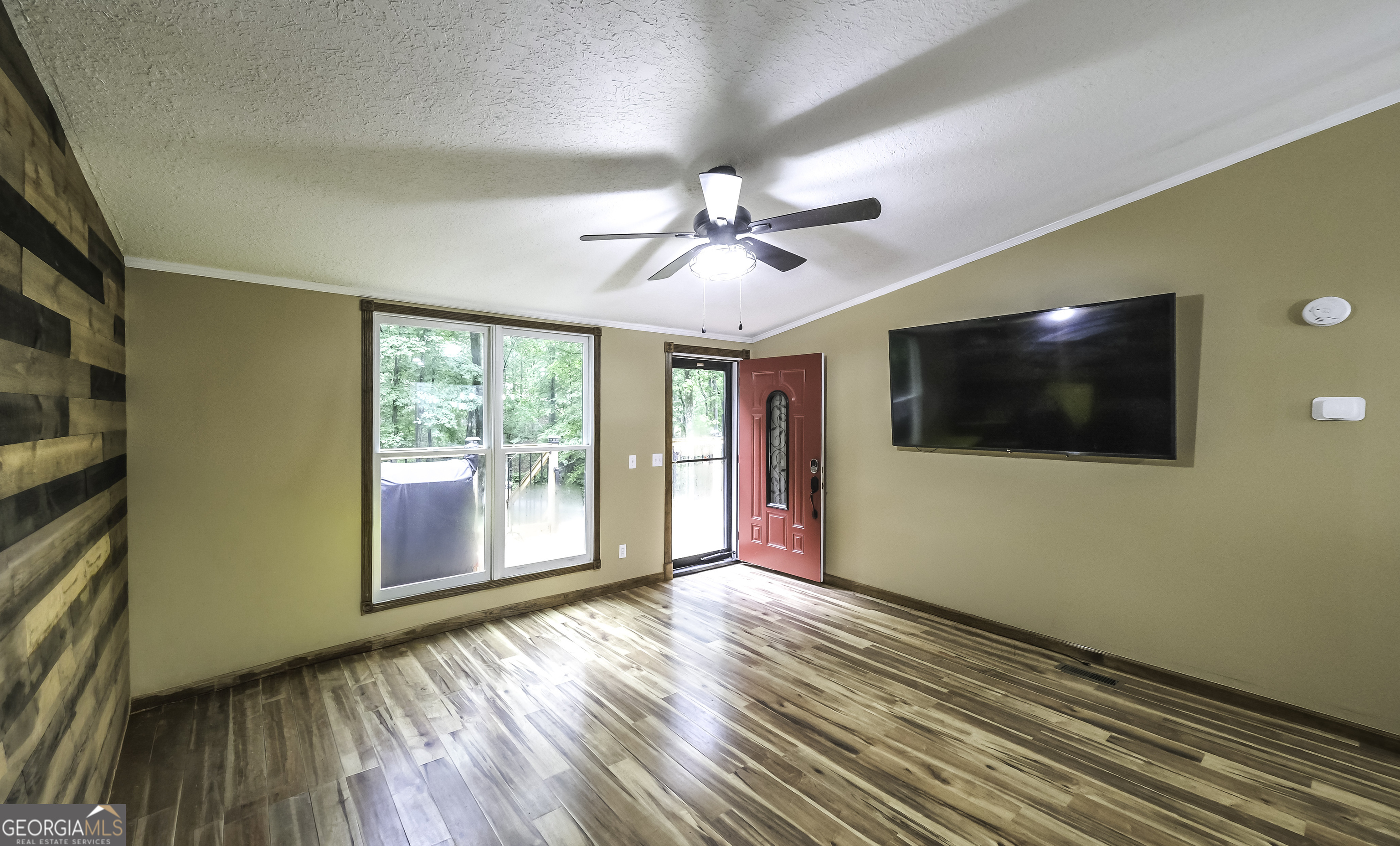 91 Holder Road Temple, GA 30179 - Photo 16 of 40 a view of an empty room with a window and wooden floor