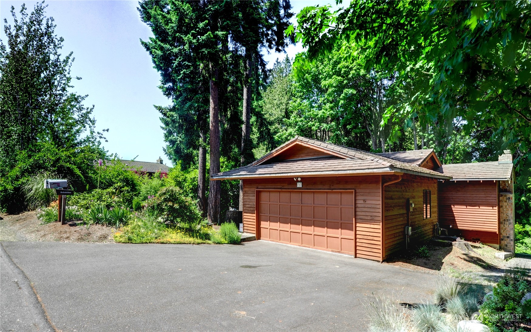 717 Daley Street Edmonds, WA 98020 - Photo 1 of 40 a front view of a house with a garden and trees