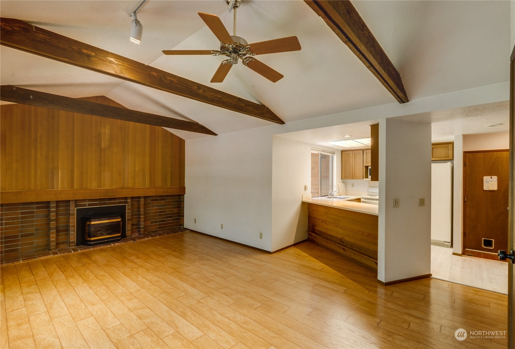 717 Daley Street Edmonds, WA 98020 - Photo 12 of 40 a view of a livingroom with furniture cabinet a ceiling fan and windows