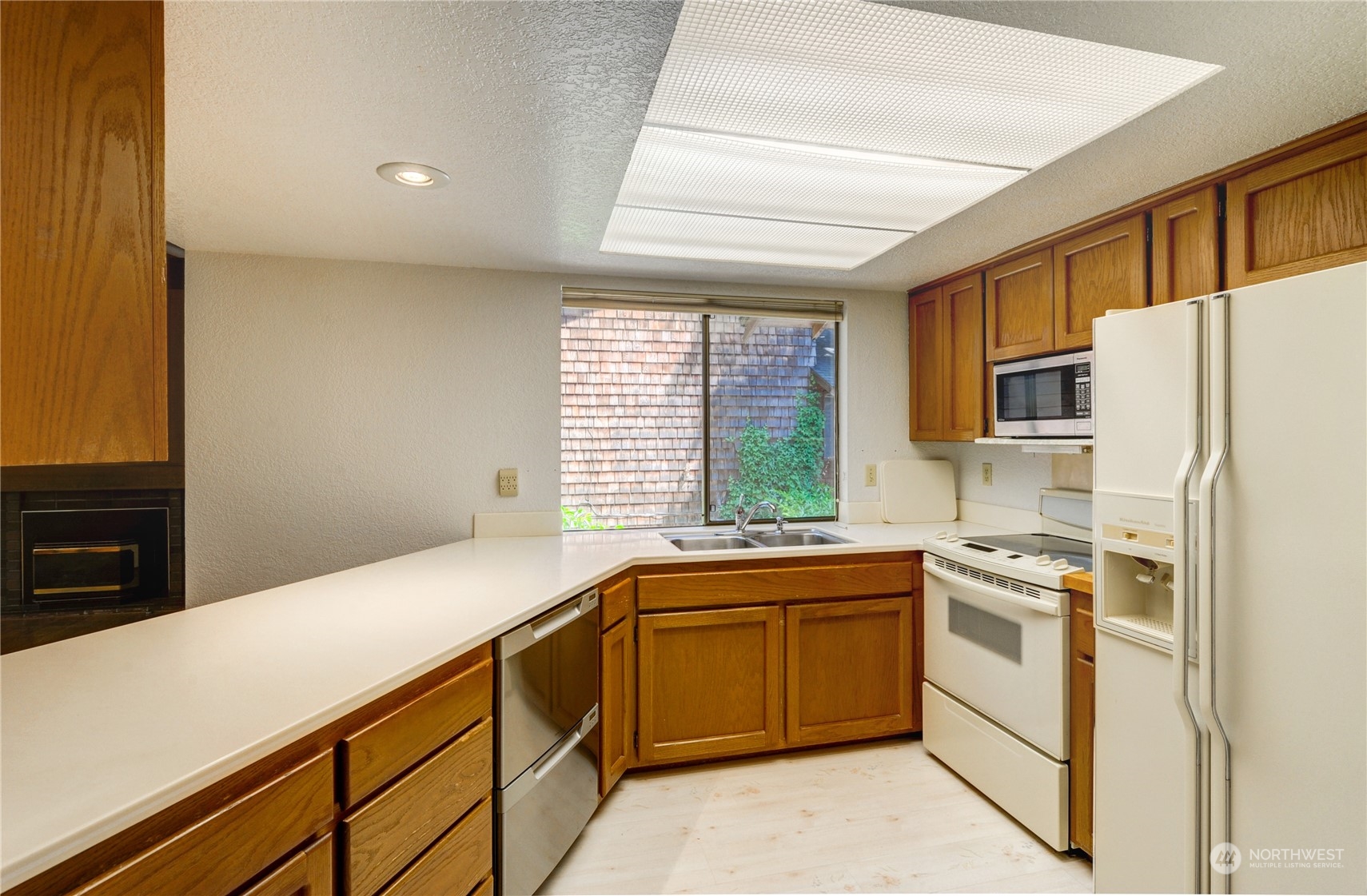717 Daley Street Edmonds, WA 98020 - Photo 13 of 40 a kitchen with a sink stove and refrigerator