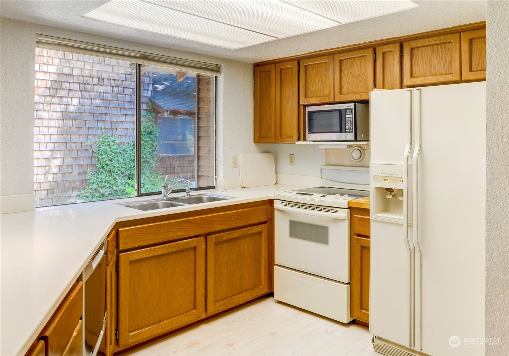 717 Daley Street Edmonds, WA 98020 - Photo 14 of 40 a kitchen with stainless steel appliances granite countertop a refrigerator and a sink