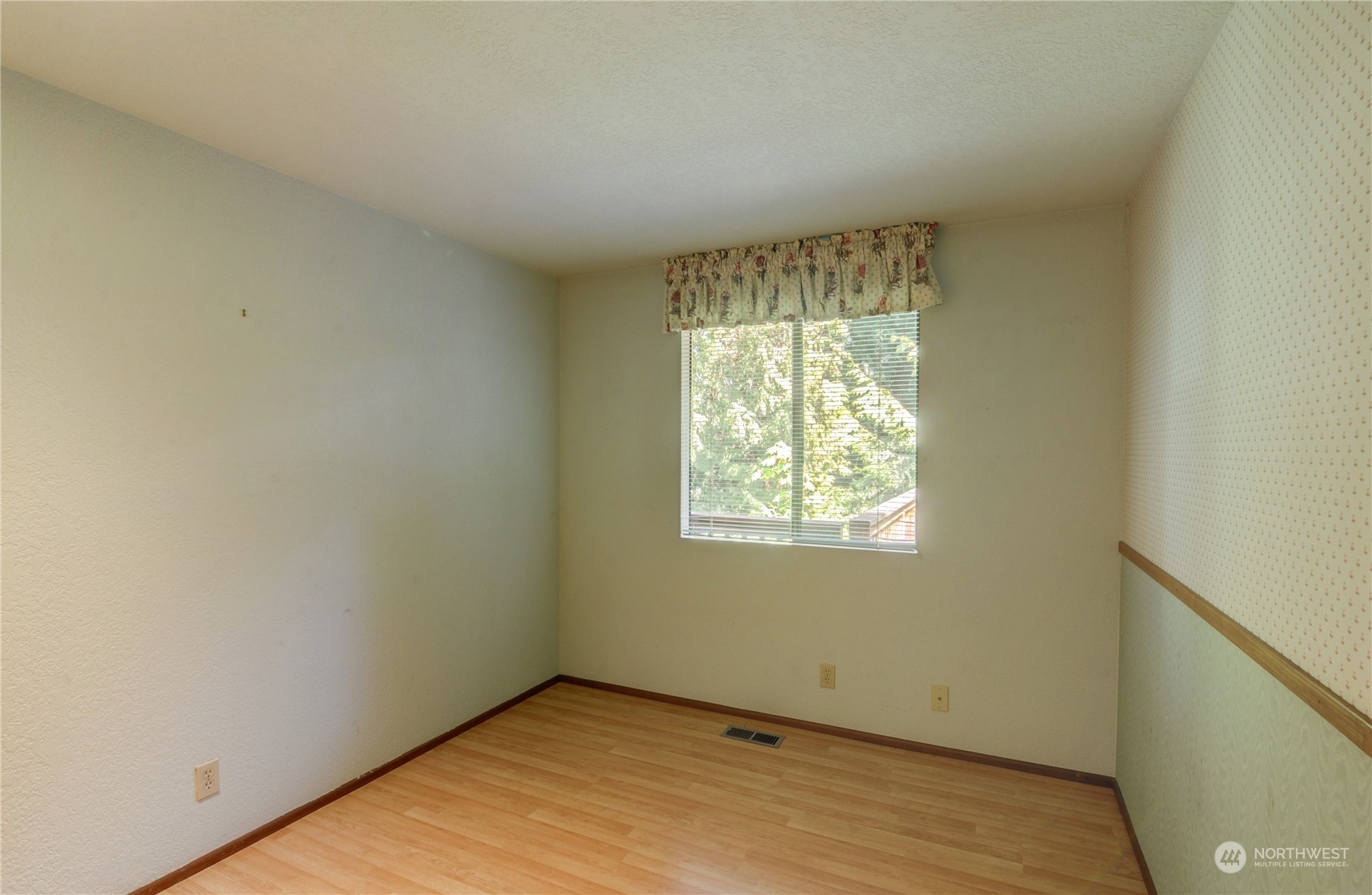 717 Daley Street Edmonds, WA 98020 - Photo 21 of 40 a view of an empty room with wooden floor and a window
