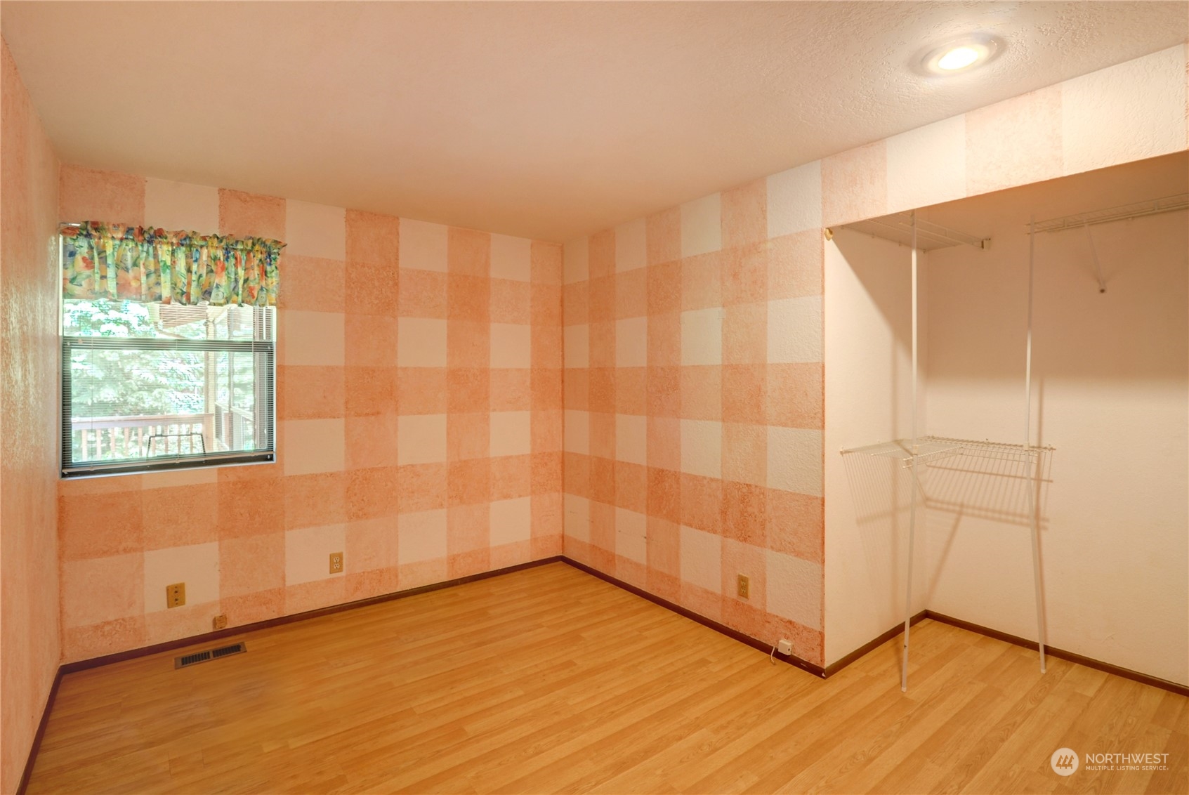 717 Daley Street Edmonds, WA 98020 - Photo 24 of 40 a view of an empty room with wooden floor and a window