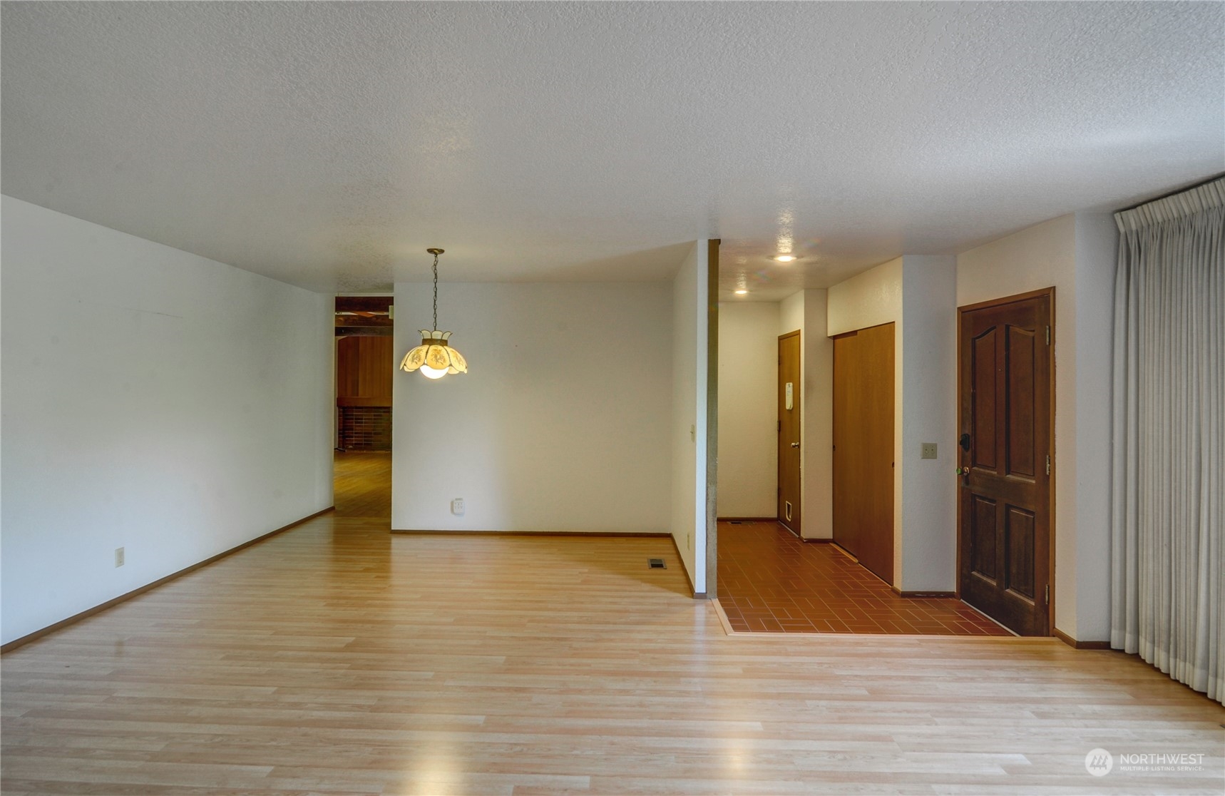 717 Daley Street Edmonds, WA 98020 - Photo 6 of 40 a view of an empty room with wooden floor and a window