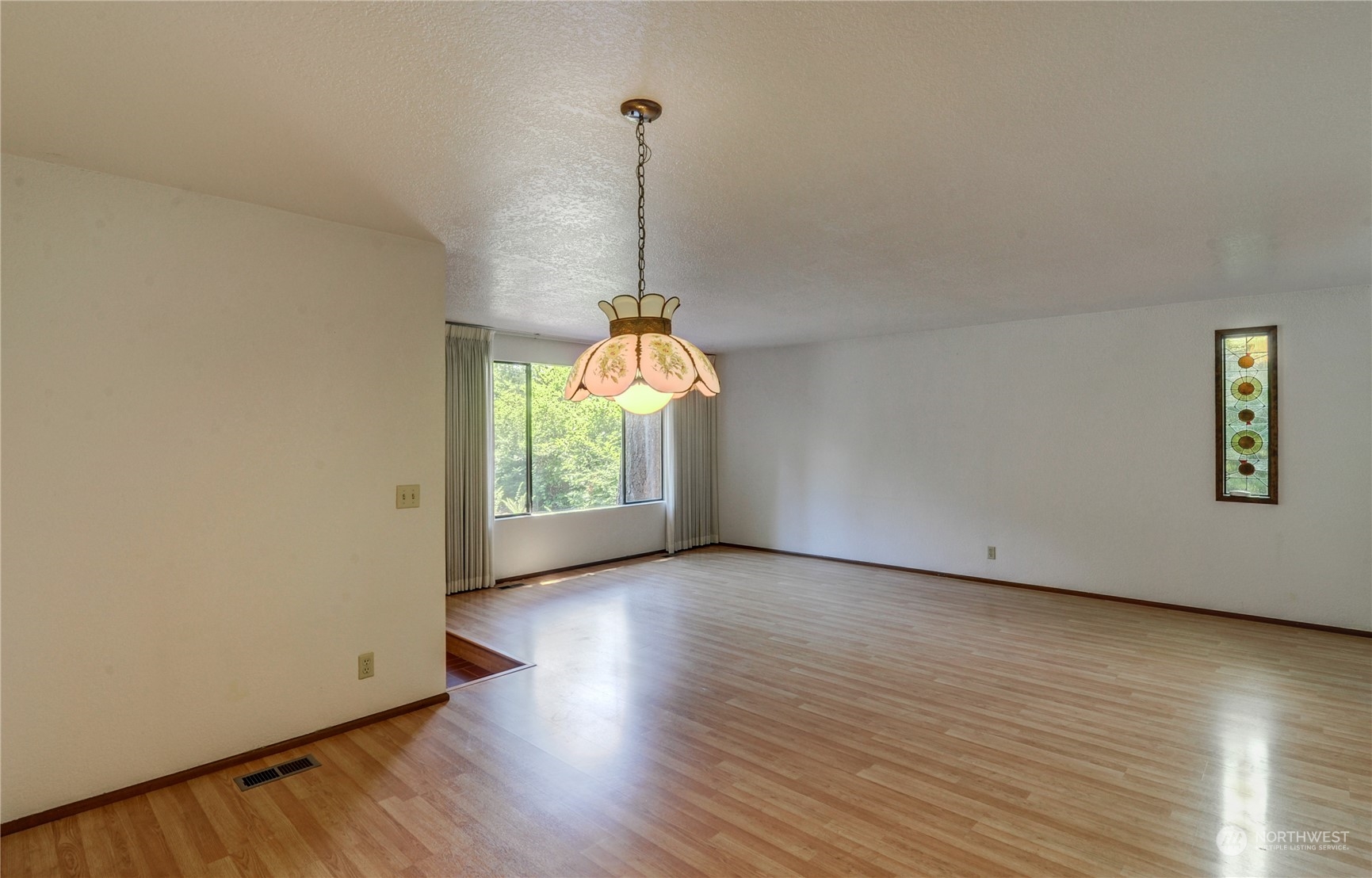 717 Daley Street Edmonds, WA 98020 - Photo 8 of 40 a view of a room with wooden floor ceiling fan and windows