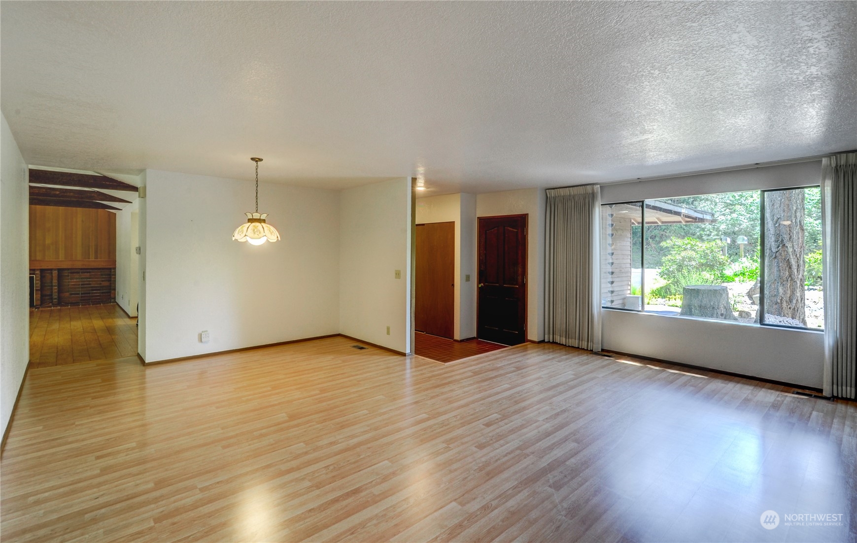 717 Daley Street Edmonds, WA 98020 - Photo 9 of 40 an empty room with wooden floor and windows