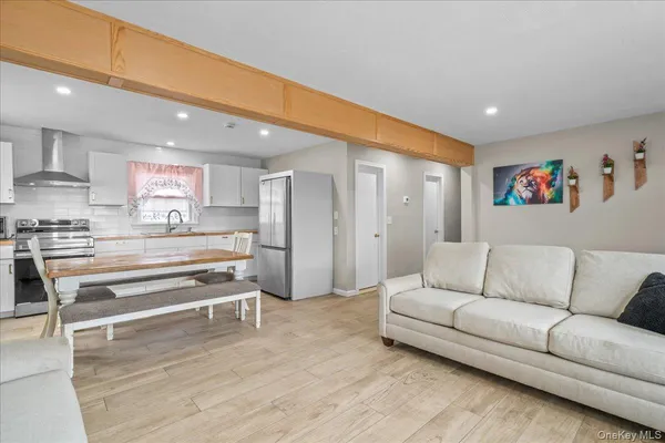 a living room with furniture and a kitchen view