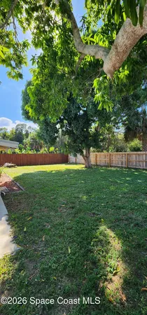 a view of yard with swimming pool and green space