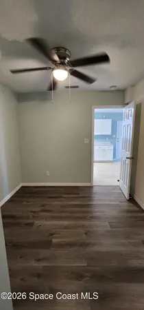 a view of a room with wooden floor and cabinet