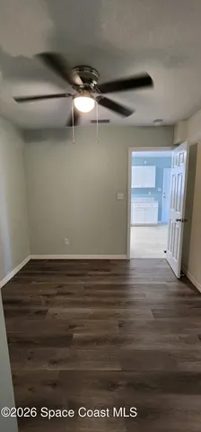 a view of a room with wooden floor and cabinet