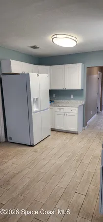a view of a kitchen with a dishwasher and a stove top oven