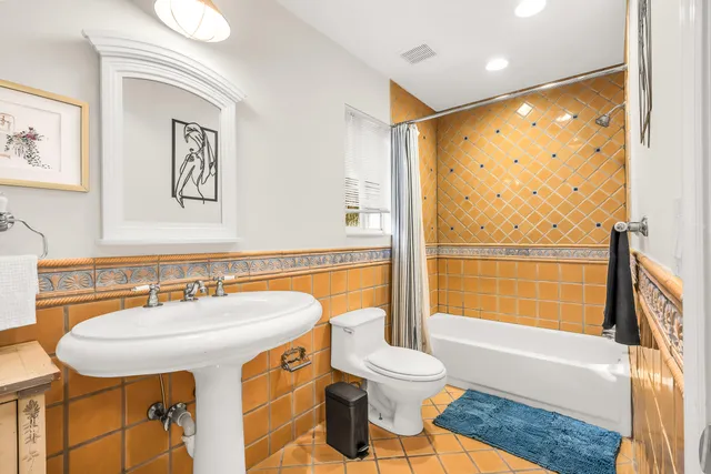 a bathroom with a sink a toilet and a bathtub