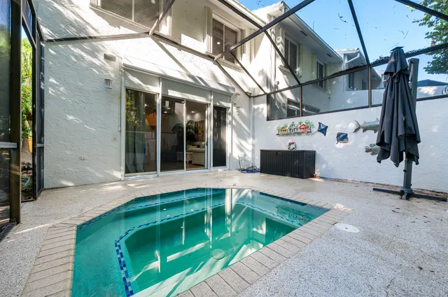 a view of backyard with outdoor seating a patio and plants