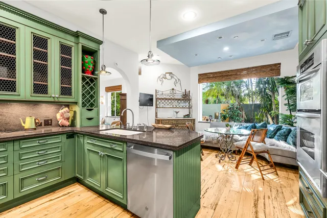 a kitchen with a large window and cabinets