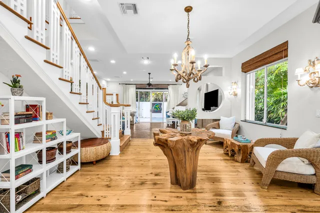 a living room with lots of furniture and a chandelier