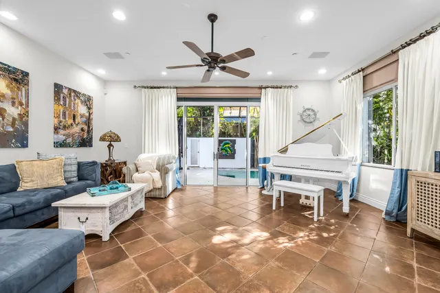 a living room with furniture a flat screen tv and a large window