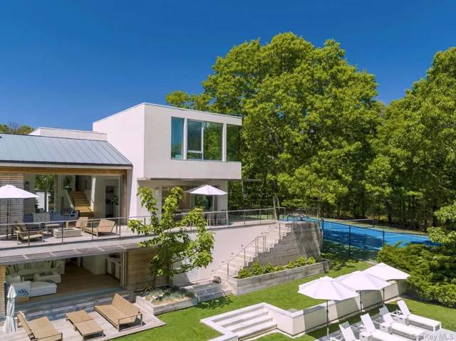 a view of a swimming pool with outdoor seating