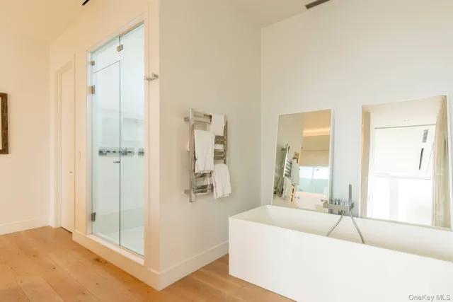 a spacious bathroom with a tub shower and window