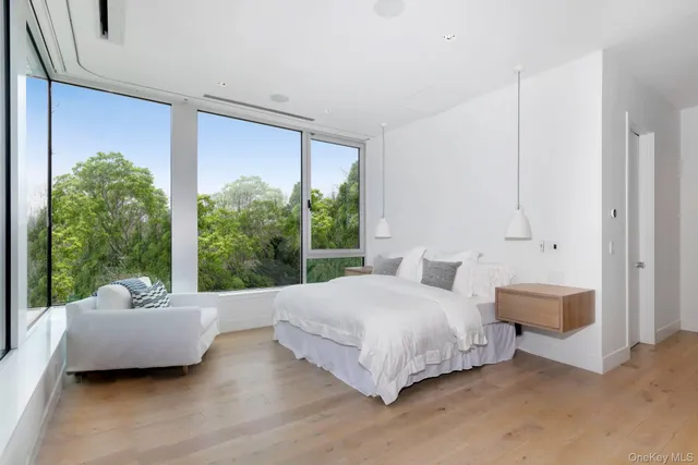 a spacious bedroom with a bed and a large window