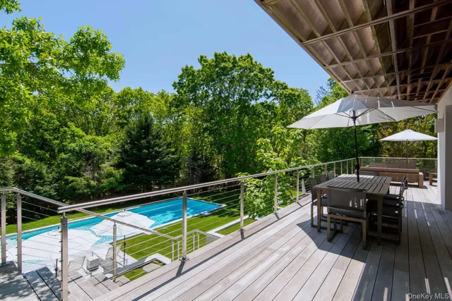 a view of balcony with chairs and wooden floor