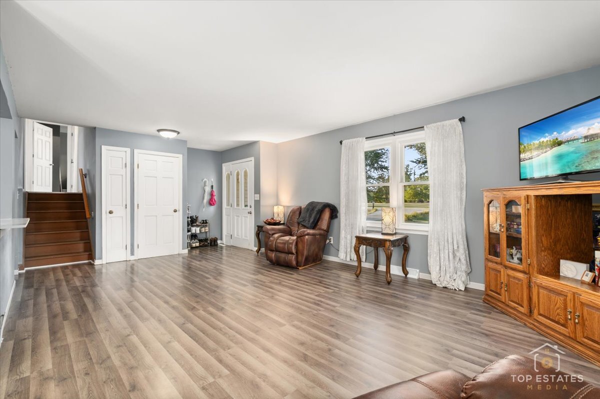 48W201 Keslinger Road Maple Park, IL 60151 - Photo 12 of 48 a living room with furniture and a flat screen tv