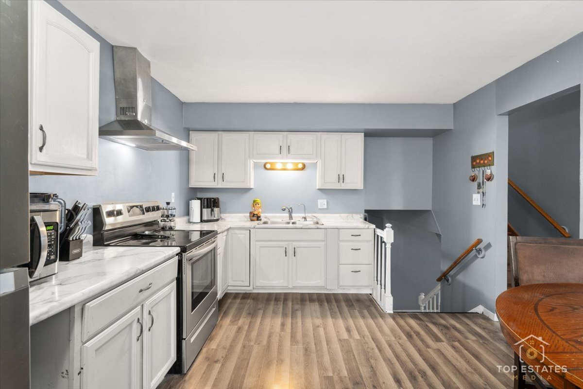 48W201 Keslinger Road Maple Park, IL 60151 - Photo 17 of 48 a kitchen with a sink stove and cabinets