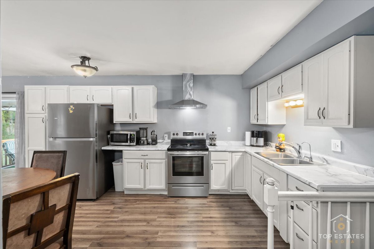 48W201 Keslinger Road Maple Park, IL 60151 - Photo 19 of 48 a kitchen with a stove a sink and a refrigerator
