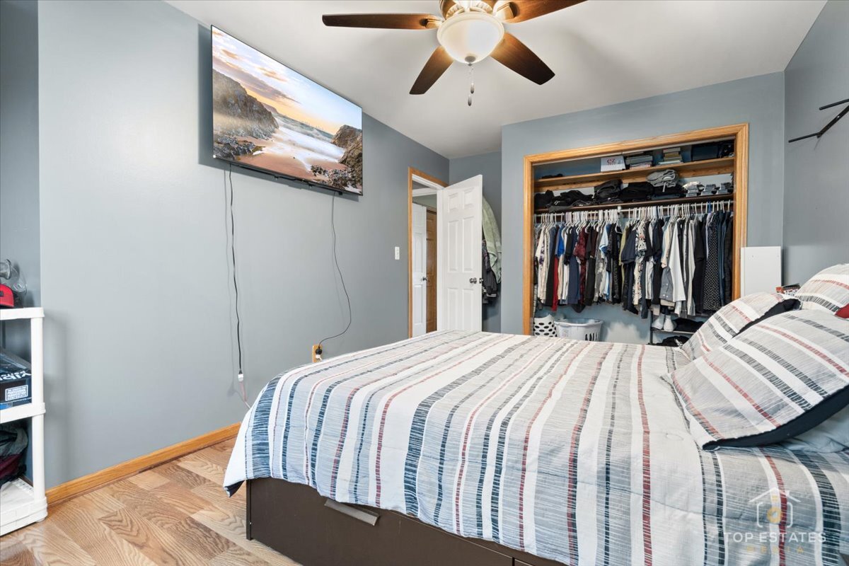 48W201 Keslinger Road Maple Park, IL 60151 - Photo 23 of 48 a bedroom with a bed and a chandelier