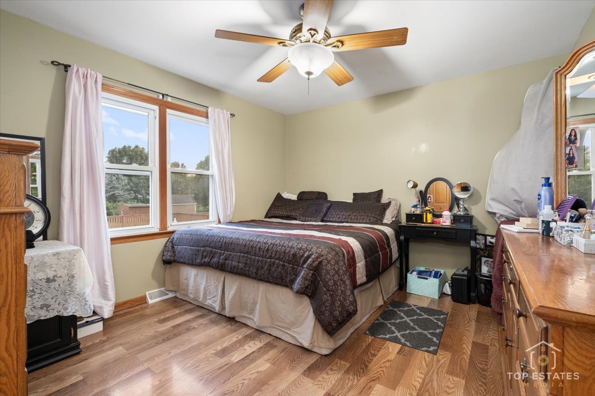 48W201 Keslinger Road Maple Park, IL 60151 - Photo 25 of 48 a spacious bedroom with a bed and a chandelier