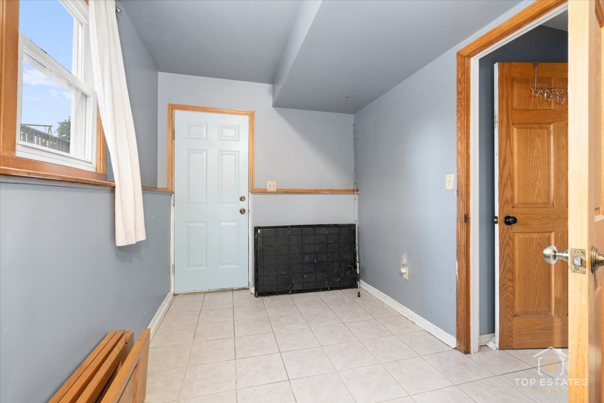 48W201 Keslinger Road Maple Park, IL 60151 - Photo 28 of 48 a view of an empty room with a fireplace and a window