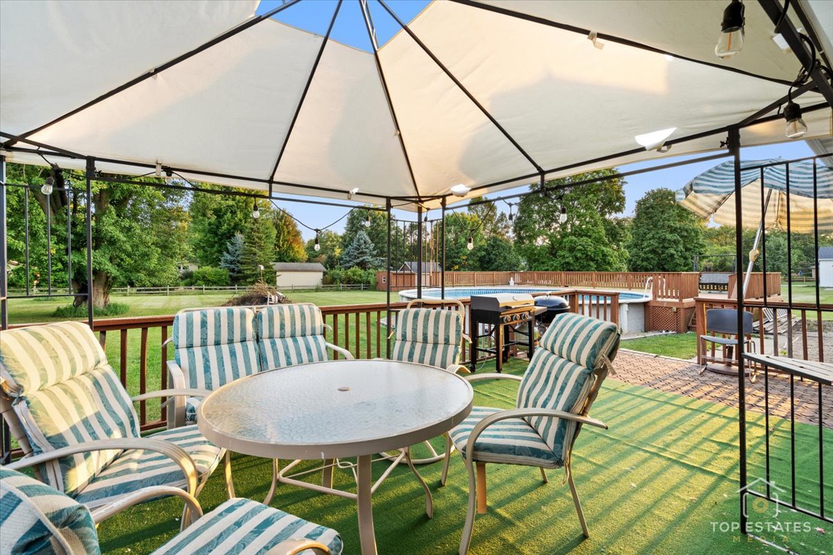 48W201 Keslinger Road Maple Park, IL 60151 - Photo 32 of 48 a view of a patio with a table chairs and a umbrella