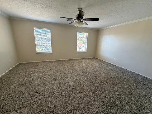 wooden floor fireplace and windows in an empty room