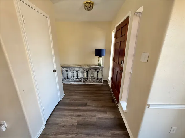 a view of an entryway with wooden floor