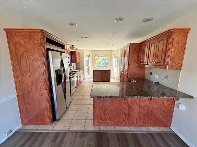 a kitchen with stainless steel appliances a refrigerator and a sink