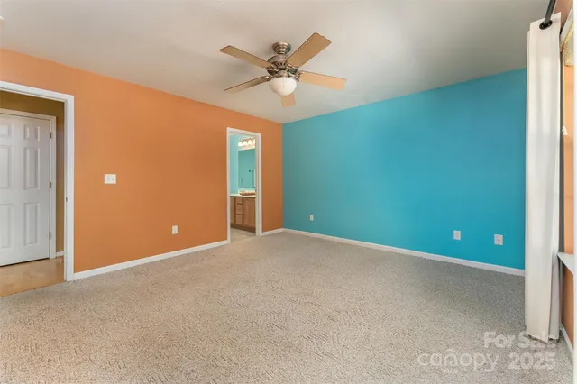 a view of an empty room with a ceiling fan