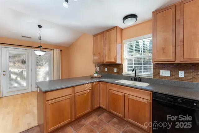 a kitchen with a sink window and cabinets