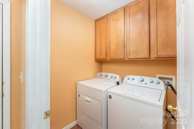 a view of storage and utility room with washer and dryer