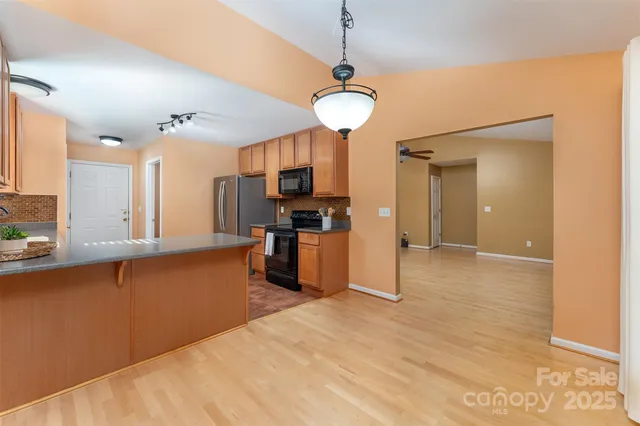 a view of a kitchen with a sink and a refrigerator