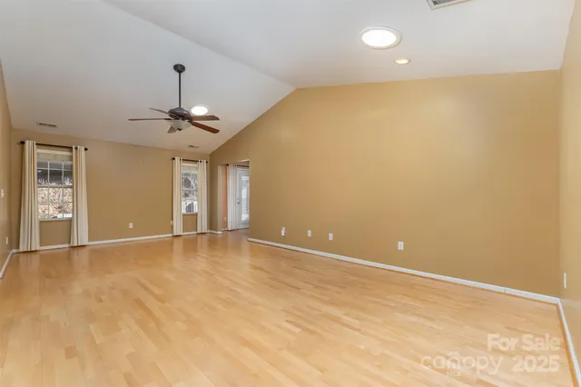 an empty room with a empty space and windows