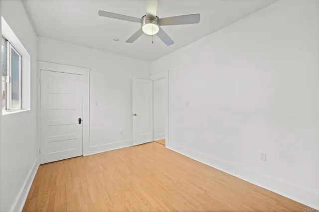 a view of a white house with large windows