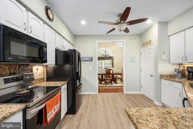a bedroom with a bed and a ceiling fan