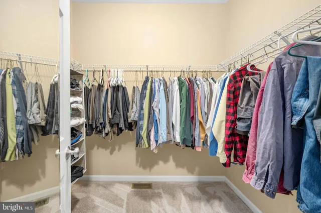 a room with furniture a rug and a painting on the wall